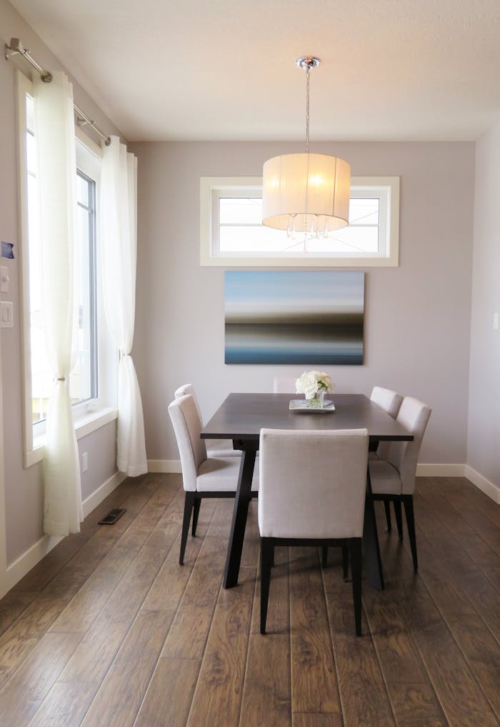 A bright, contemporary dining room with minimalist decor and modern furnishings.